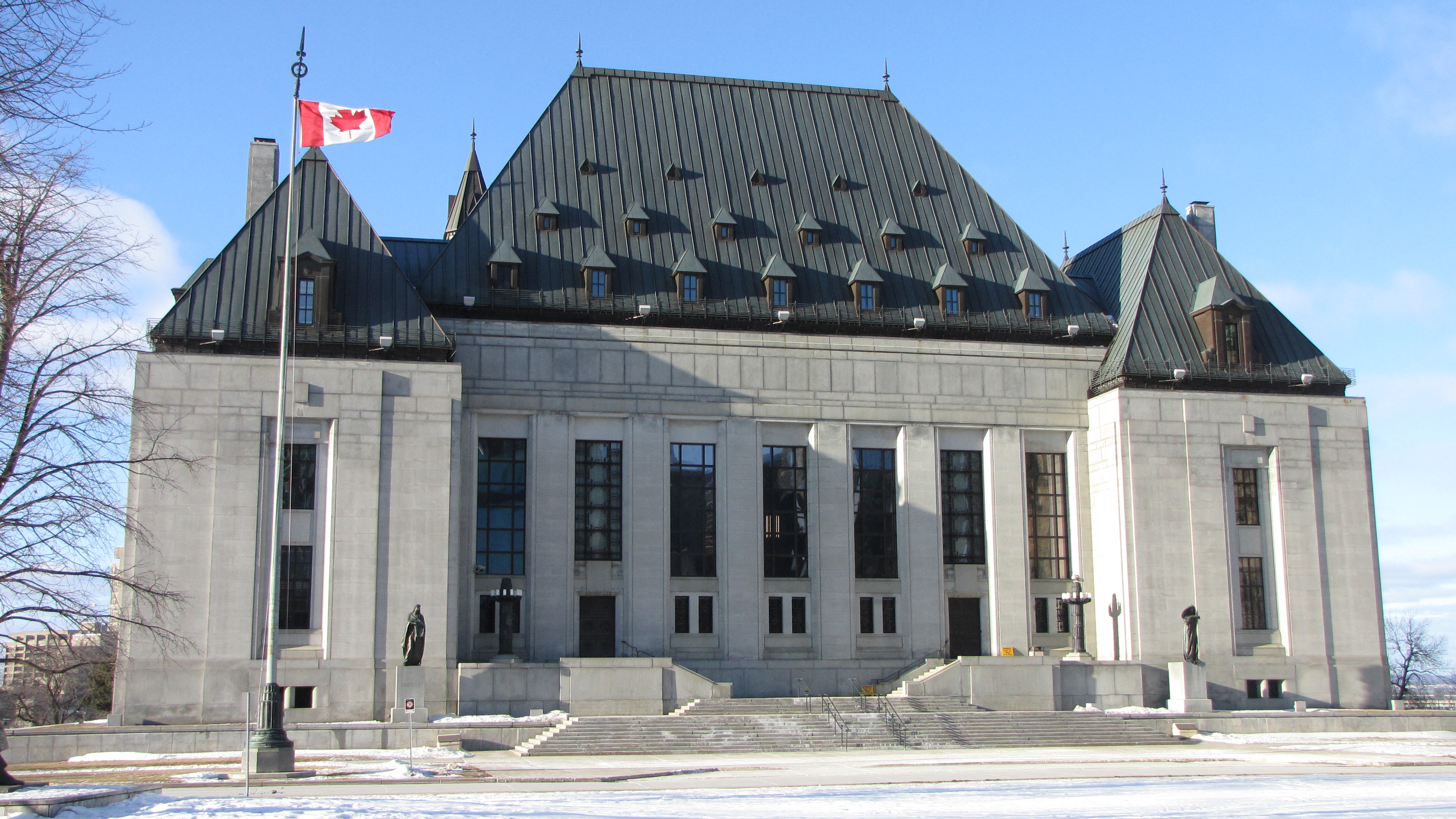 Exterior shot of the Supreme Court of Canada building on a sunny day