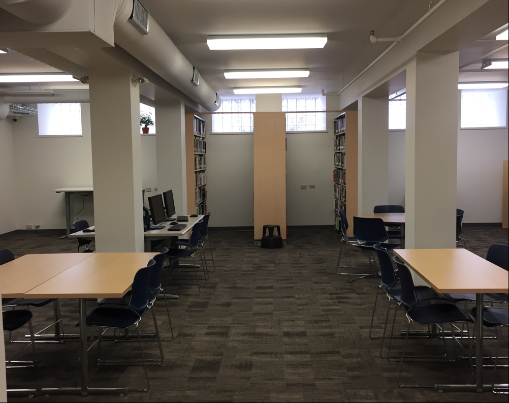the part of the library. Middle of the room has tables with chairs around them. Along a wall is 3 book shelfs sticking inwards towards the middle of the room. For more description contact Meredith Fischer, m e f i s c h e r @ w l u dot c a