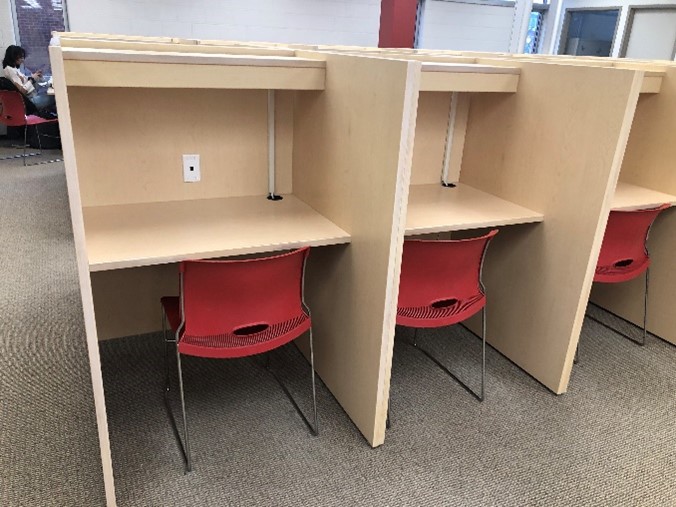 Study carrells side by side. These are study desks next to each other with partitions between them for privacy.