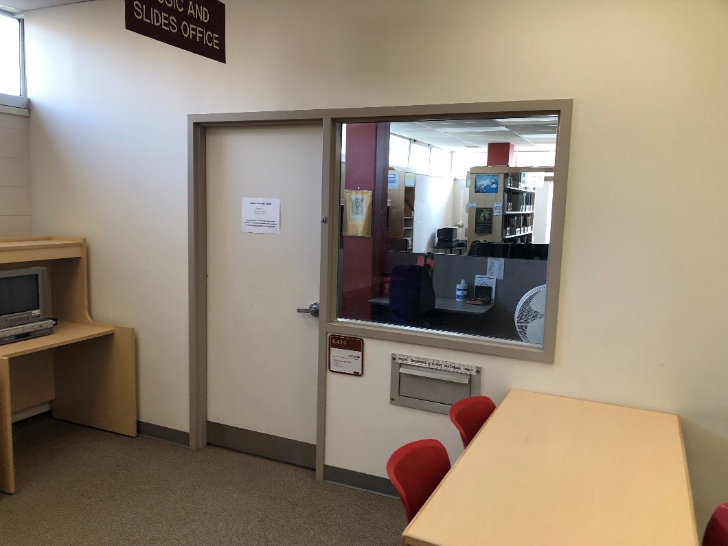 The ensemble room has a door and large window into the room. Beneath the window is a slot for returning materials