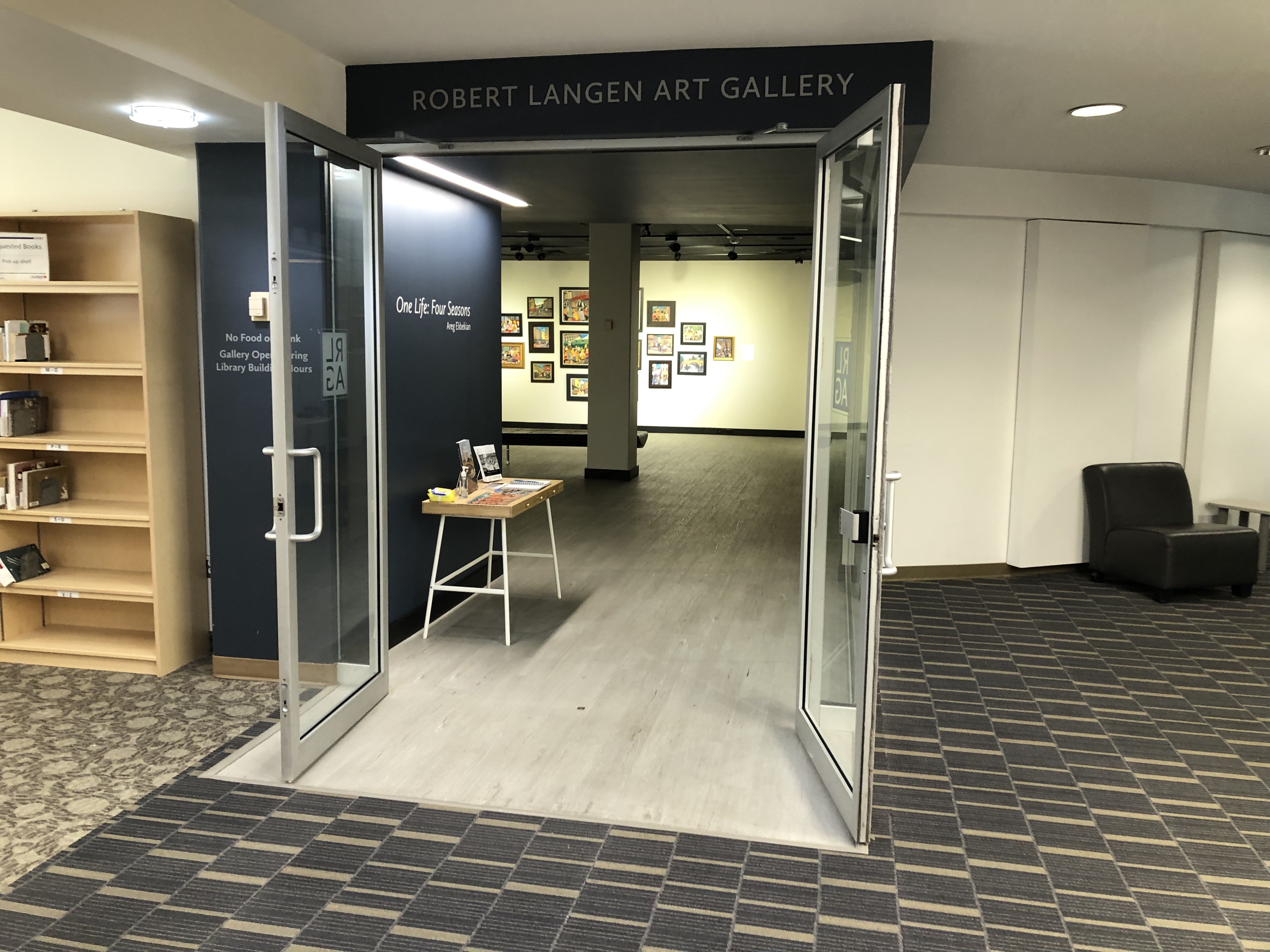 The entrance to the gallery. The doors are open towards the lobby. The surface of the gallery floor is solid, while the library lobby is carpeted.