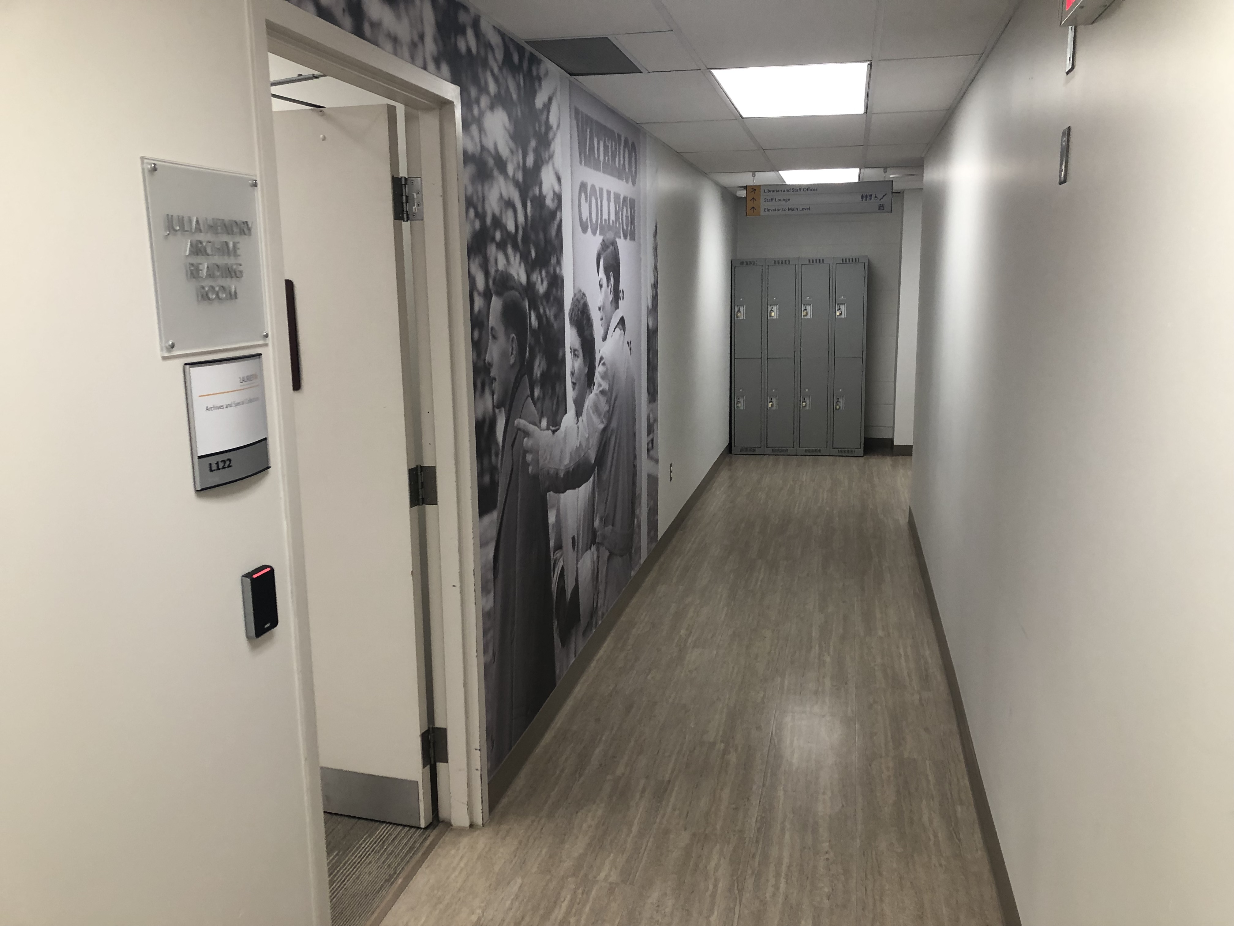 Hallway with a set of lockers and entrance to the reading room, Braille door sign, L122