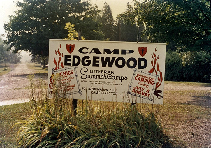 Sign in long grass for Camp Edgewood Lutheran Summer Camps.