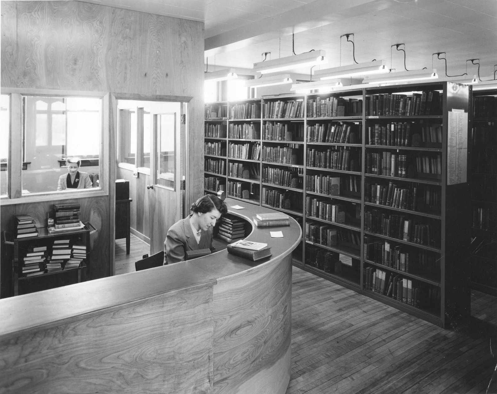 Interior of the library in Willison Hall with librarian behind desk