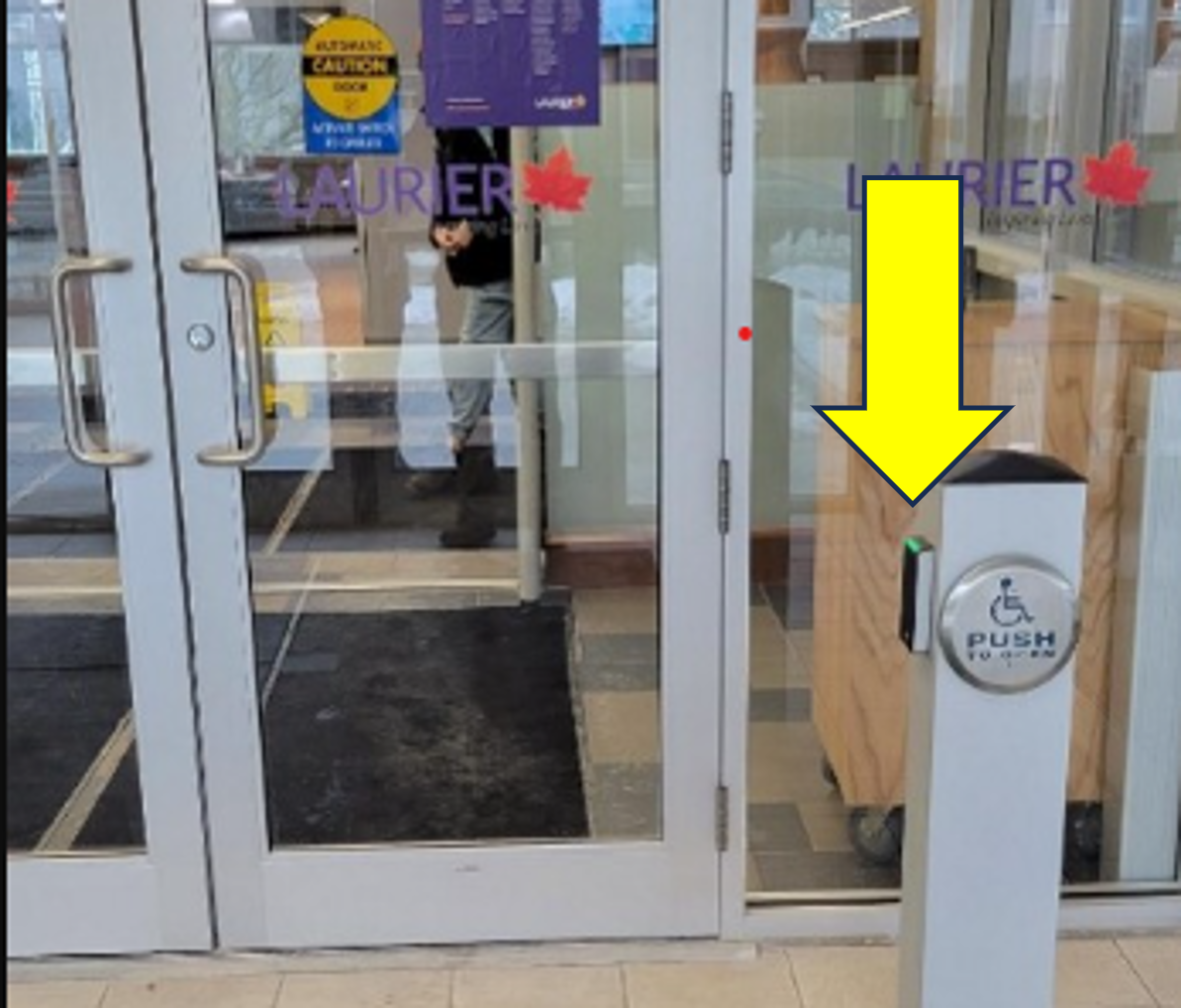 Interior area between main and second set of doors. A bollard has a one card tap area, near a round door opener.