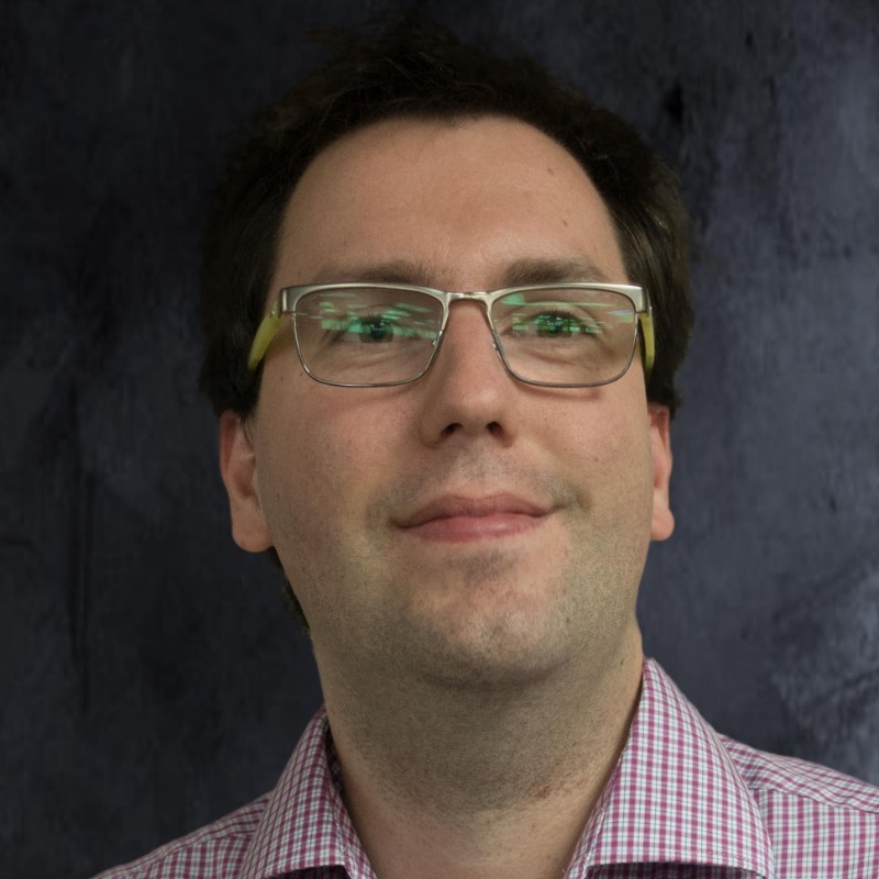 Ryan Robinson headshot with plain gray background