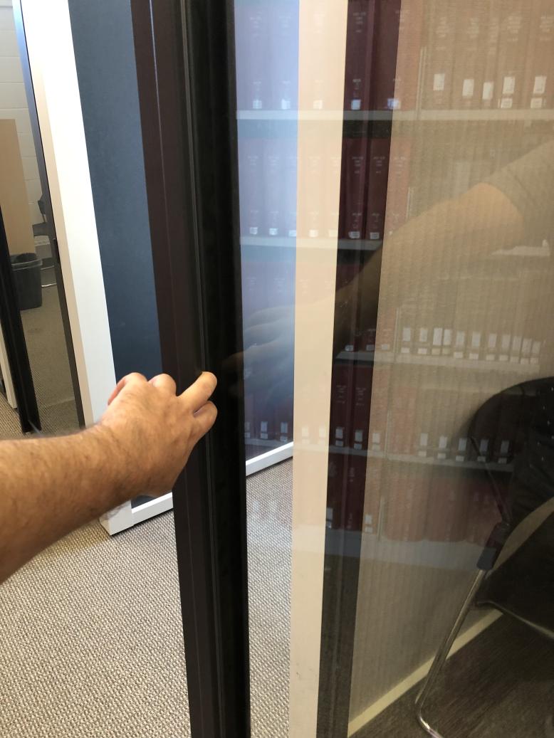 A hand opening the glass door with two fingers. Description of pods follows at heading 2