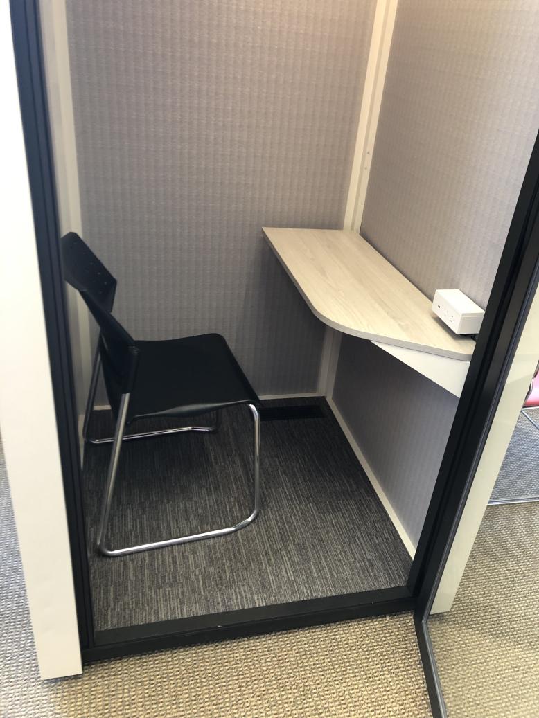 Study pod showing chair, desk, and a step from floor to interior. Description of pods follows at heading 2