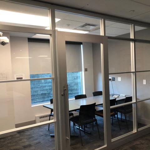 Group study room, a table with chairs seen through glass windows.