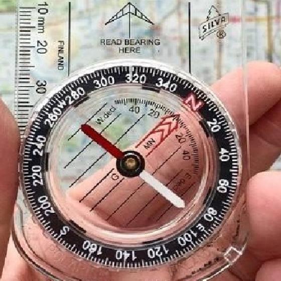 Hand holding a compass